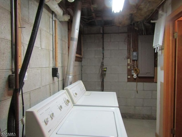 clothes washing area with separate washer and dryer and electric panel