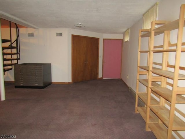 basement featuring dark colored carpet