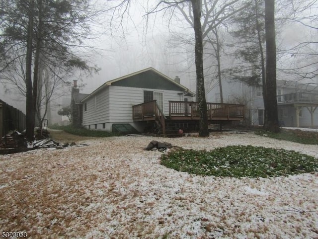 back of house featuring a wooden deck