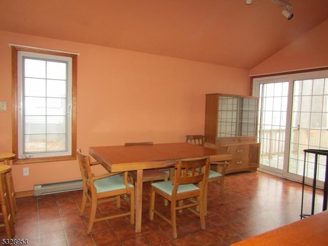 dining area with a baseboard radiator and lofted ceiling