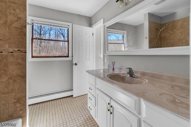 bathroom featuring tile patterned flooring, vanity, and a baseboard heating unit