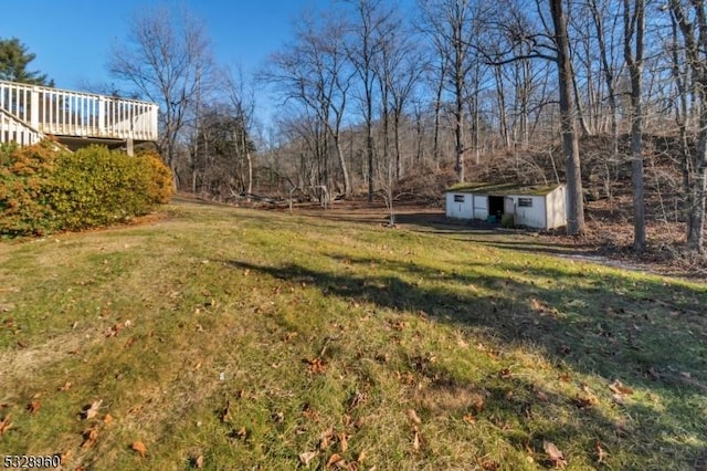 view of yard featuring a shed and a deck