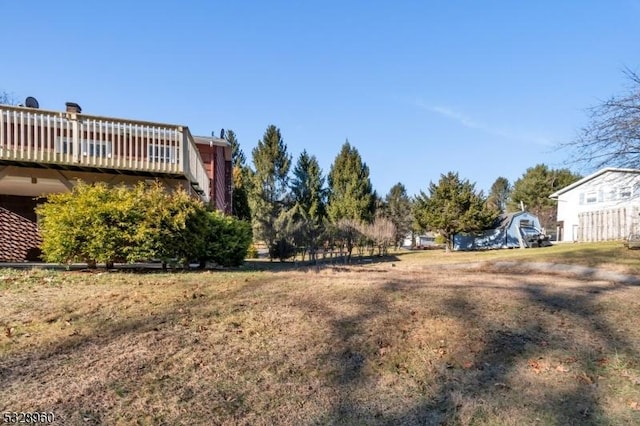 view of yard with a wooden deck