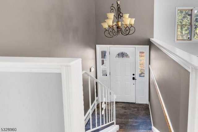 foyer entrance featuring dark hardwood / wood-style flooring and an inviting chandelier