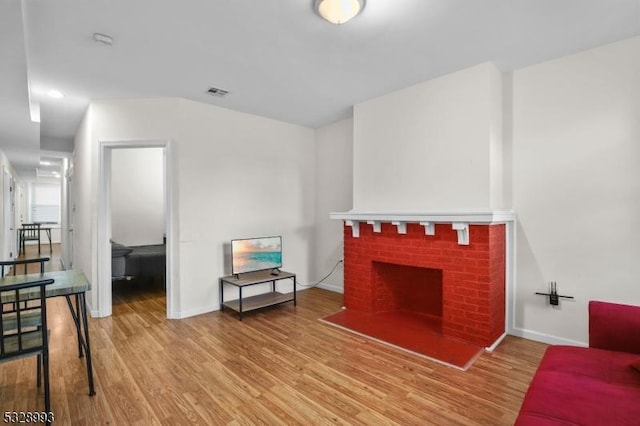 living room featuring a fireplace and hardwood / wood-style flooring