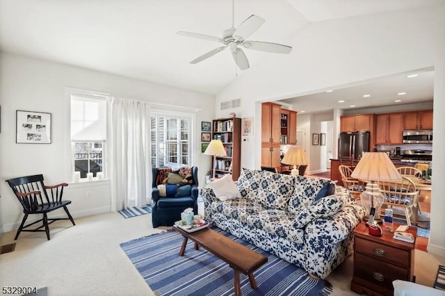 carpeted living room with vaulted ceiling and ceiling fan