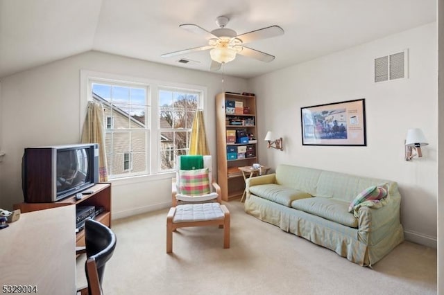 carpeted living room with ceiling fan and lofted ceiling