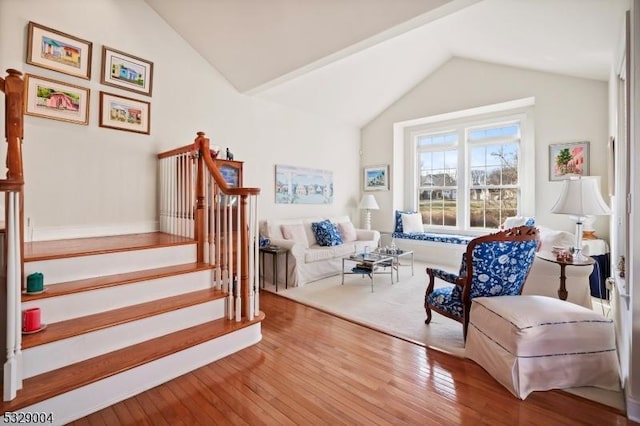 sitting room with hardwood / wood-style floors and vaulted ceiling