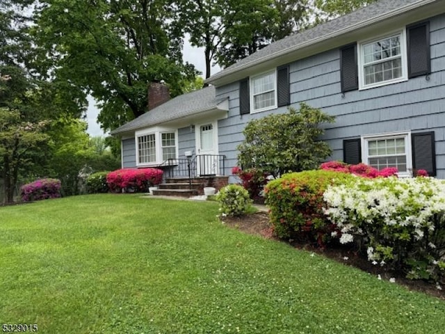 back of property featuring a lawn