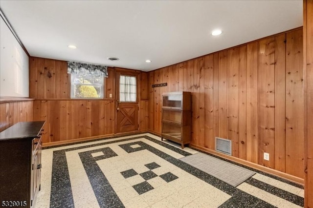 interior space featuring wooden walls