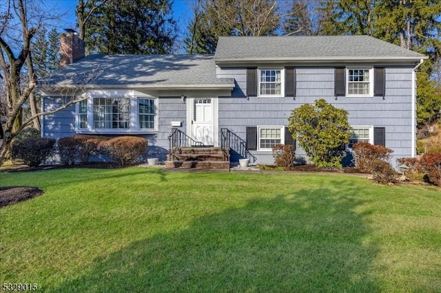 tri-level home with a front lawn