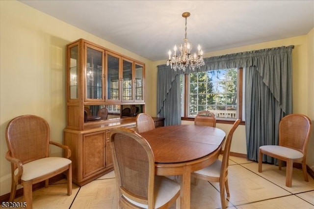 dining space featuring a chandelier and light parquet flooring