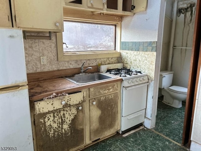 kitchen with sink and white appliances