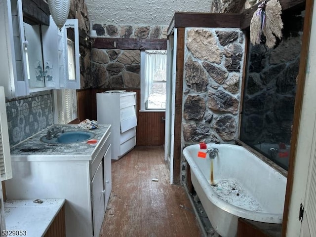 bathroom featuring a bathing tub, vanity, and wood-type flooring