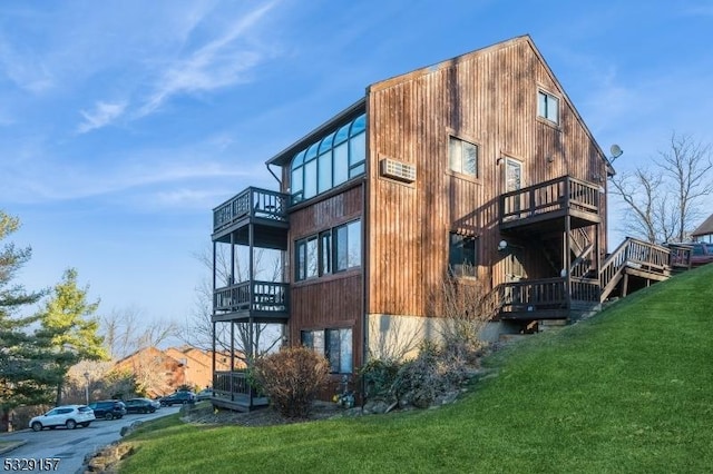 view of property exterior with a balcony and a yard