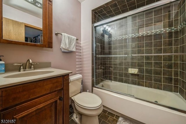 full bathroom with tile patterned flooring, vanity, toilet, and bath / shower combo with glass door