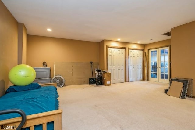 carpeted bedroom with multiple closets and french doors