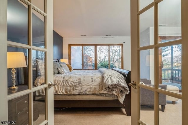 bedroom with french doors and carpet floors