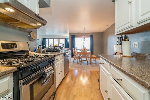 kitchen with white cabinetry, exhaust hood, and appliances with stainless steel finishes