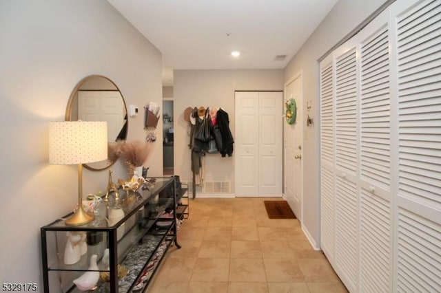 hall with light tile patterned floors