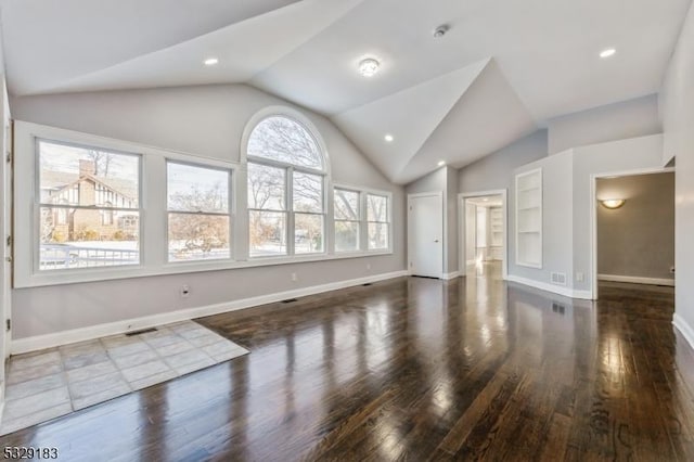 unfurnished living room featuring lofted ceiling, dark hardwood / wood-style flooring, built in features, and a wealth of natural light