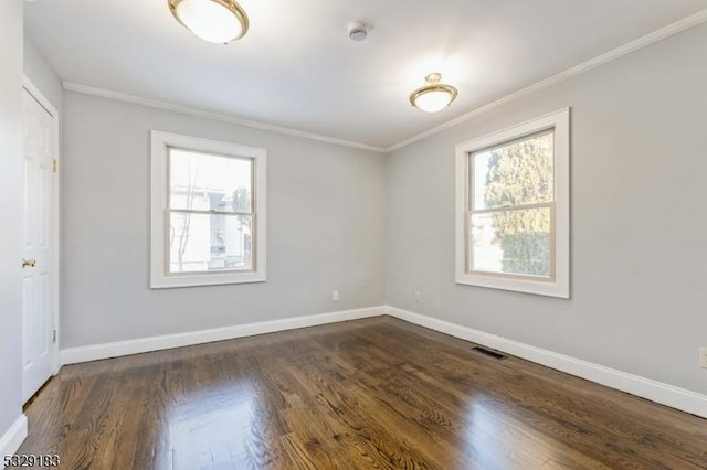 spare room with dark hardwood / wood-style flooring and ornamental molding