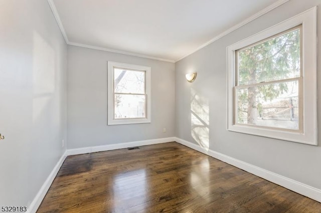 empty room featuring dark hardwood / wood-style flooring and crown molding