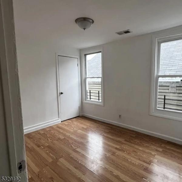 spare room with light hardwood / wood-style floors and a wealth of natural light