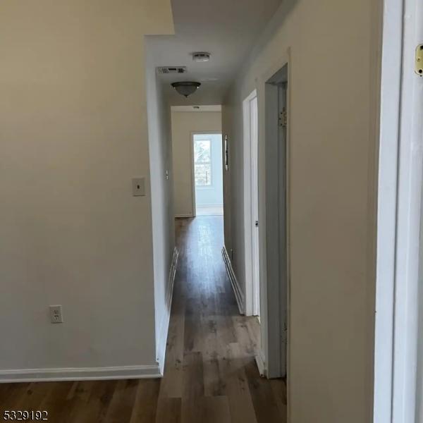 corridor with dark hardwood / wood-style floors