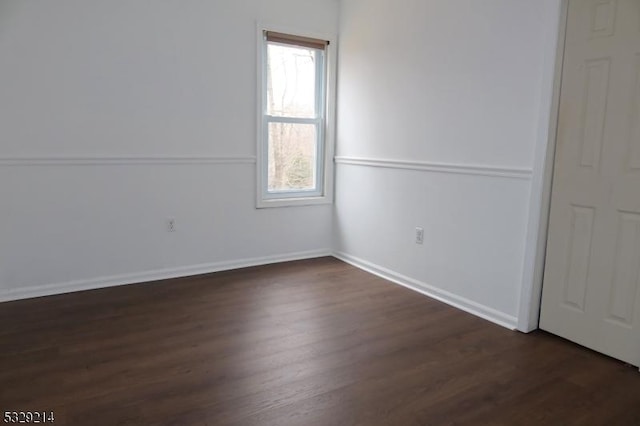 unfurnished room featuring dark hardwood / wood-style flooring