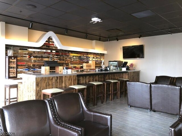 200 State Rt 94 Unit 338, Vernon Twp, NJ 07462 - bar area featuring a drop ceiling, wood finished floors, and wine cooler