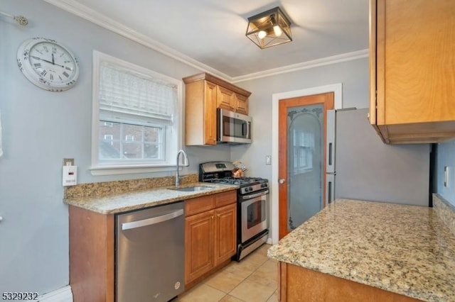 kitchen featuring light stone countertops, stainless steel appliances, crown molding, sink, and light tile patterned floors