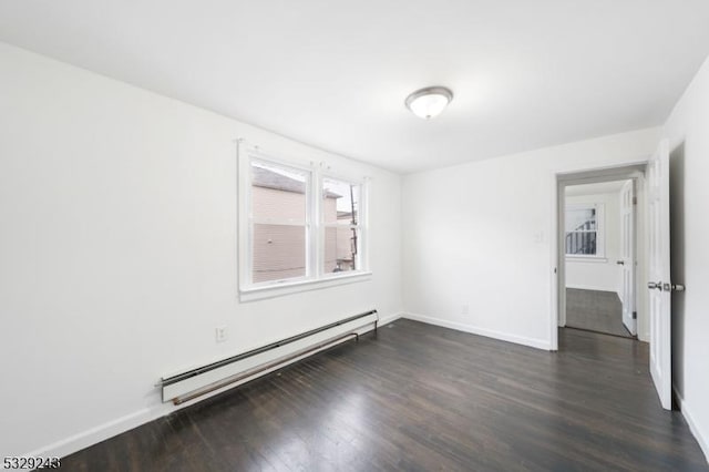 unfurnished room with baseboard heating and dark wood-type flooring