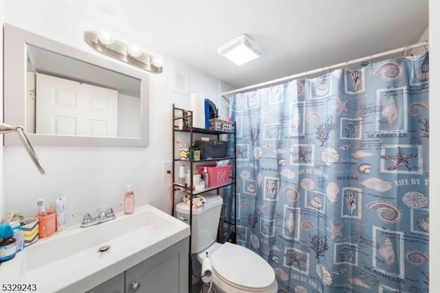 bathroom with vanity, toilet, and walk in shower