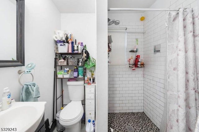 bathroom featuring curtained shower, sink, and toilet