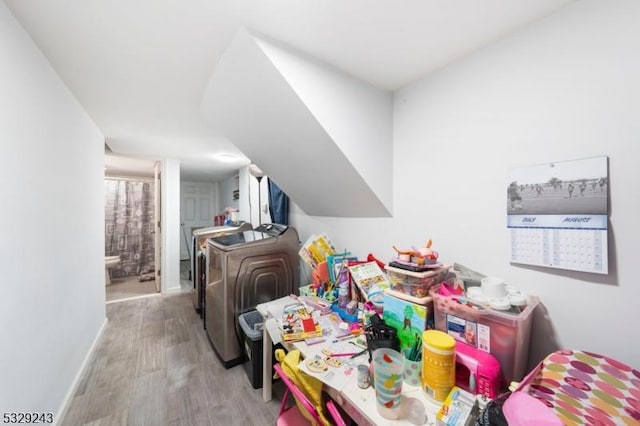 interior space featuring separate washer and dryer and light hardwood / wood-style flooring