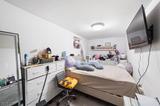 bedroom with dark wood-type flooring