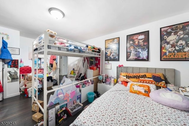 bedroom with dark hardwood / wood-style floors