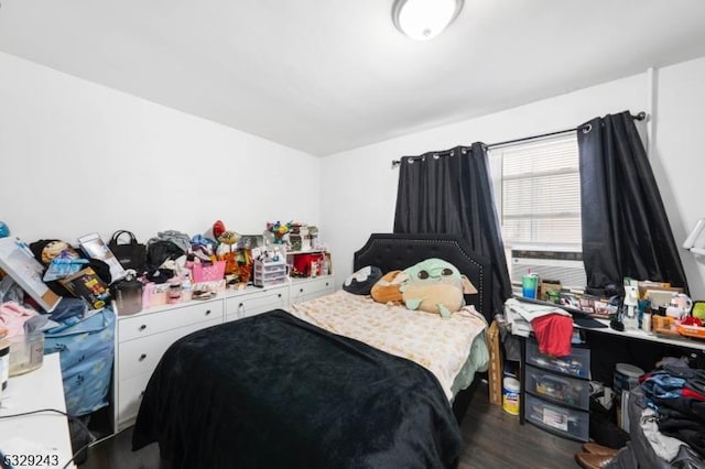 bedroom with dark wood-type flooring