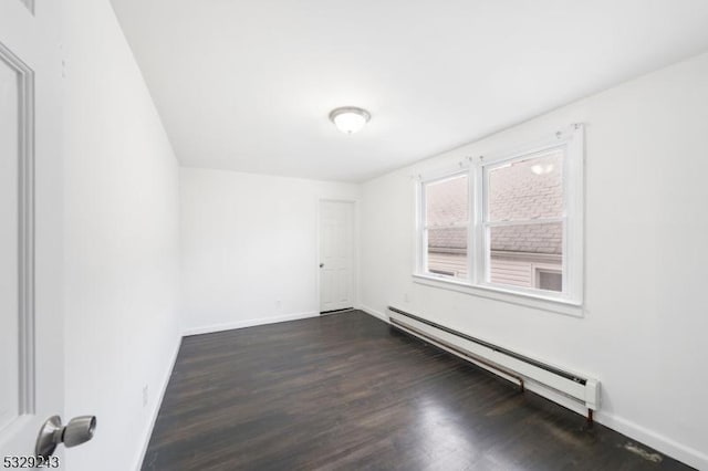 unfurnished room with dark wood-type flooring and a baseboard radiator