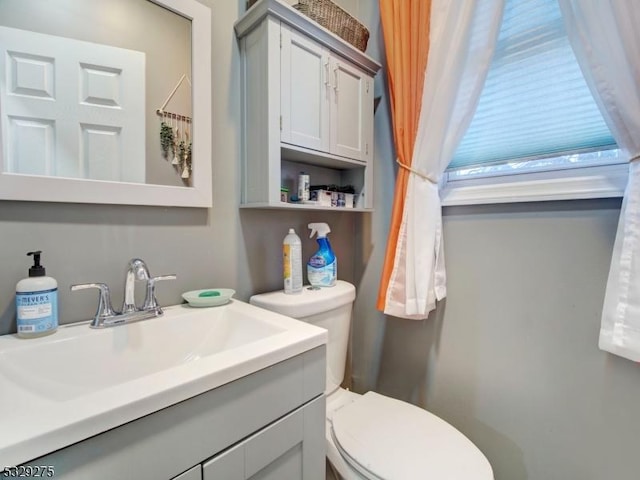 bathroom featuring vanity and toilet