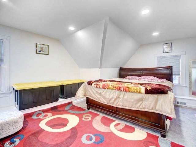 bedroom featuring carpet and lofted ceiling