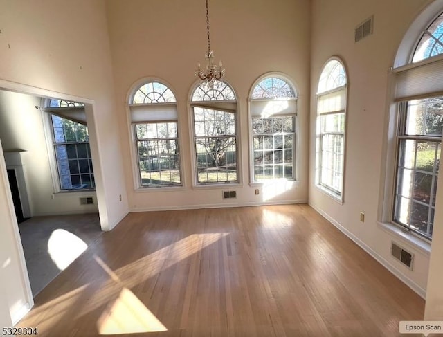 unfurnished sunroom with an inviting chandelier