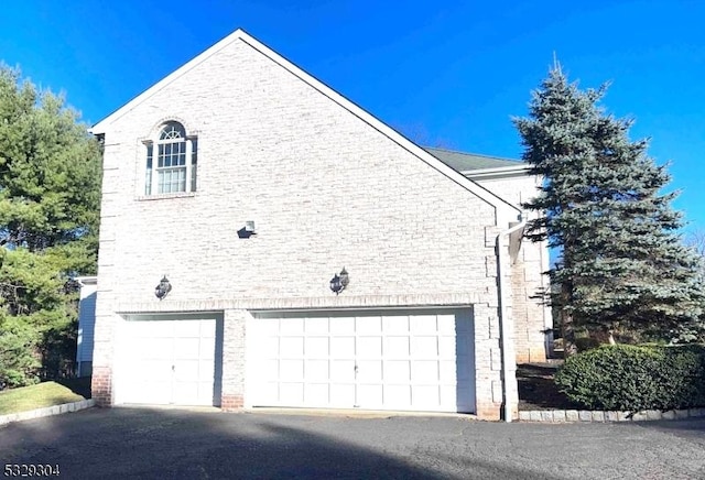 view of side of home featuring a garage