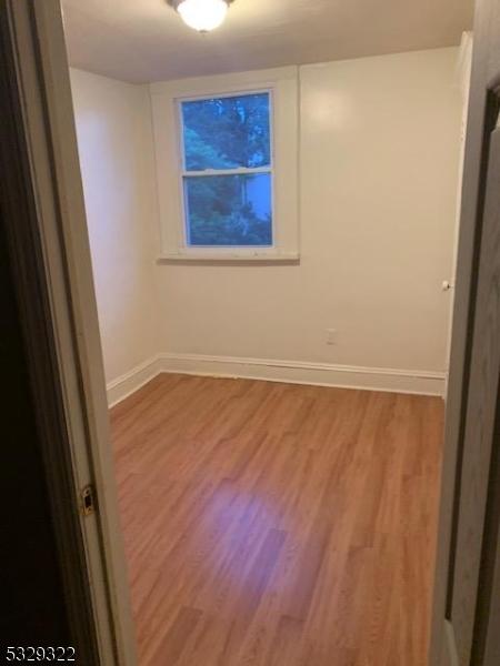 unfurnished room featuring hardwood / wood-style flooring