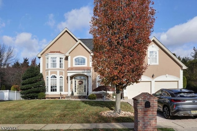 view of front property with a garage and a front lawn