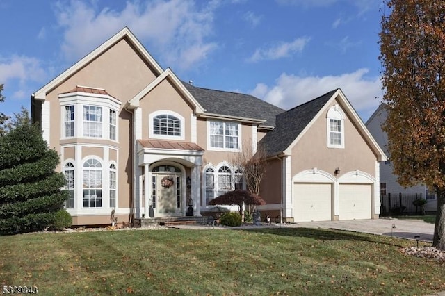 front of property featuring a front yard and a garage