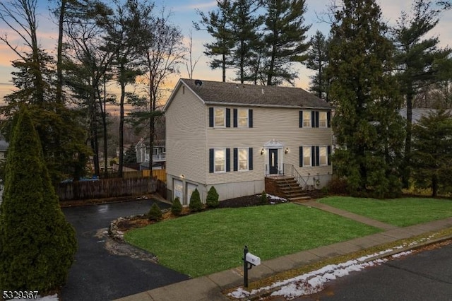 colonial-style house featuring a yard