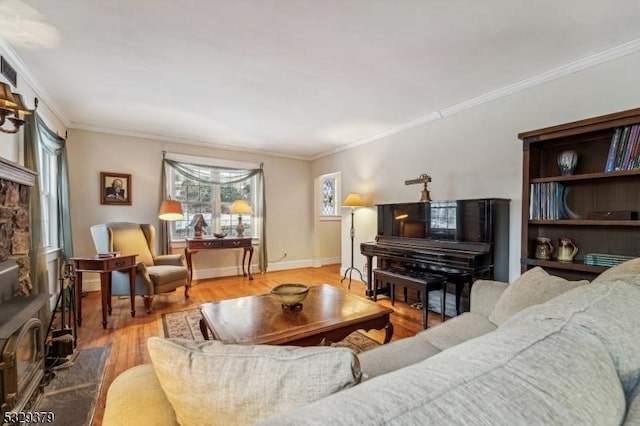 living room featuring light hardwood / wood-style floors, a wood stove, and crown molding