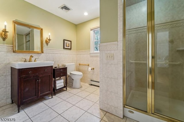 bathroom featuring a baseboard radiator, tile patterned flooring, toilet, a shower with door, and vanity